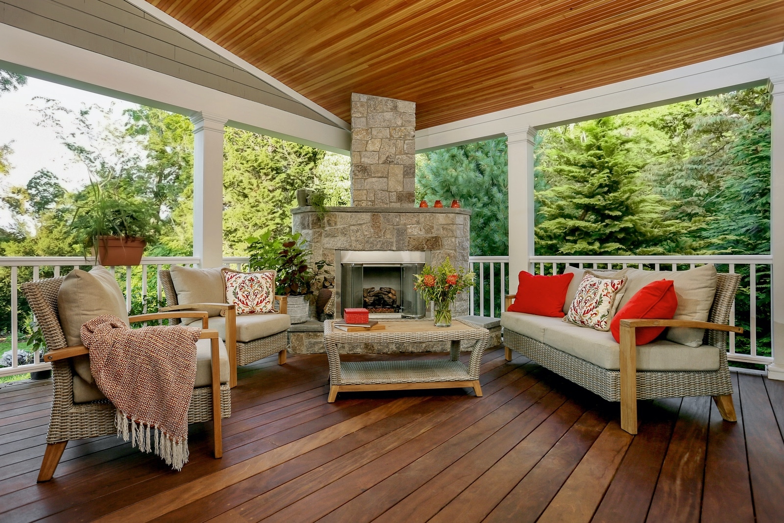 Sunroom cozy design with pillows throws and fireplace